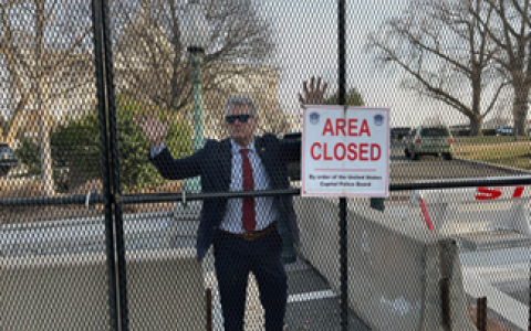 Mike at fence outside capitol